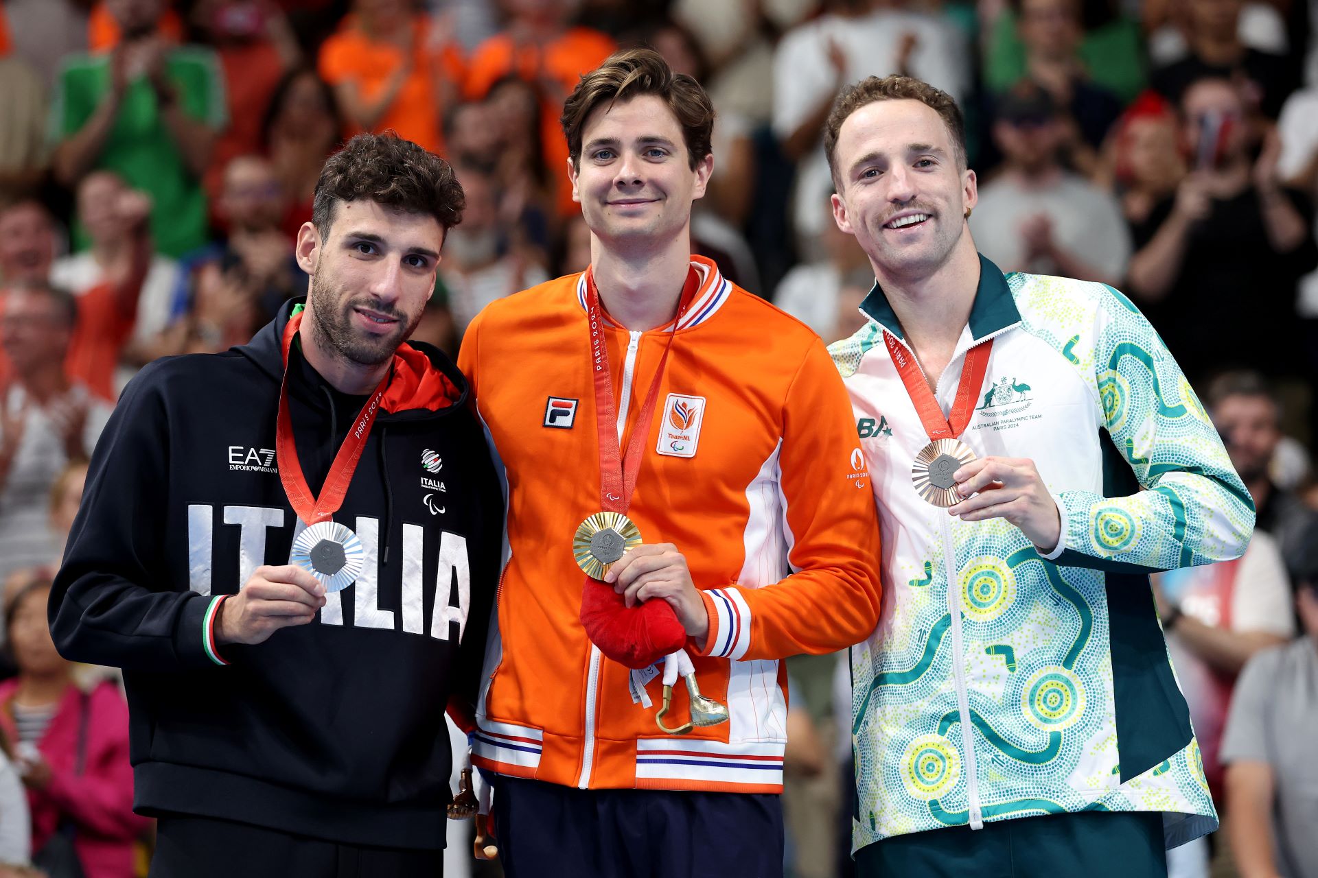 Tom Gallagher stands on the podium at the Paris Paralympics with a bronze medal in the Men's S10 100 metres Backstroke