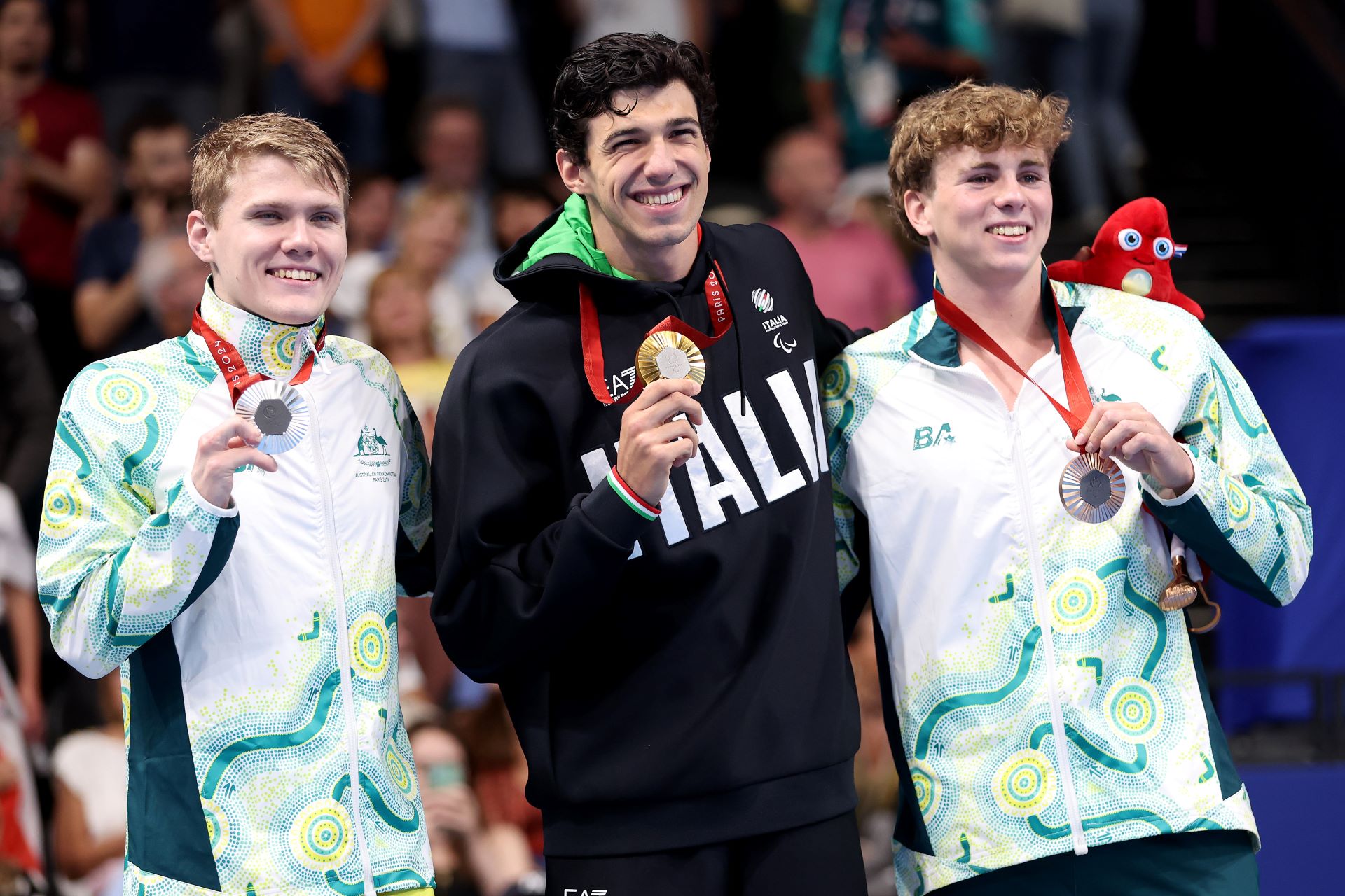 Lewis Bishop stands on the podium after winning bronze in the final of the Men's S9 100 metres Butterfly